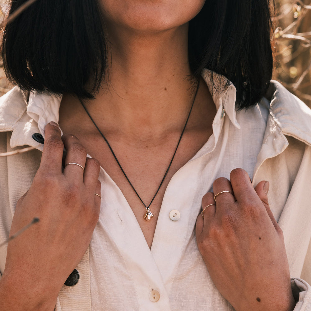 ocean pebble necklace worn with white shirt and white jacket