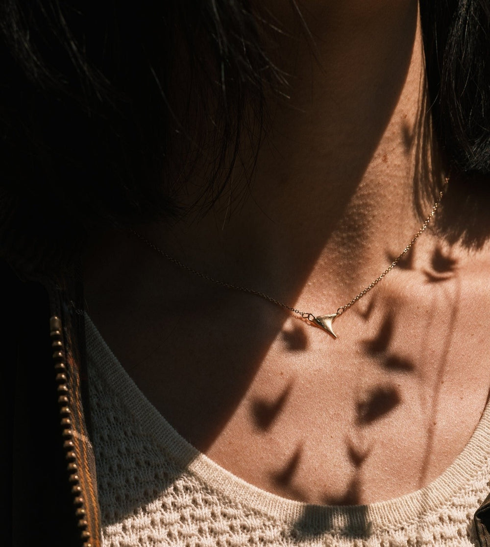 gold wild rose thorn necklace worn with white lace dress and waxed canvas jacket