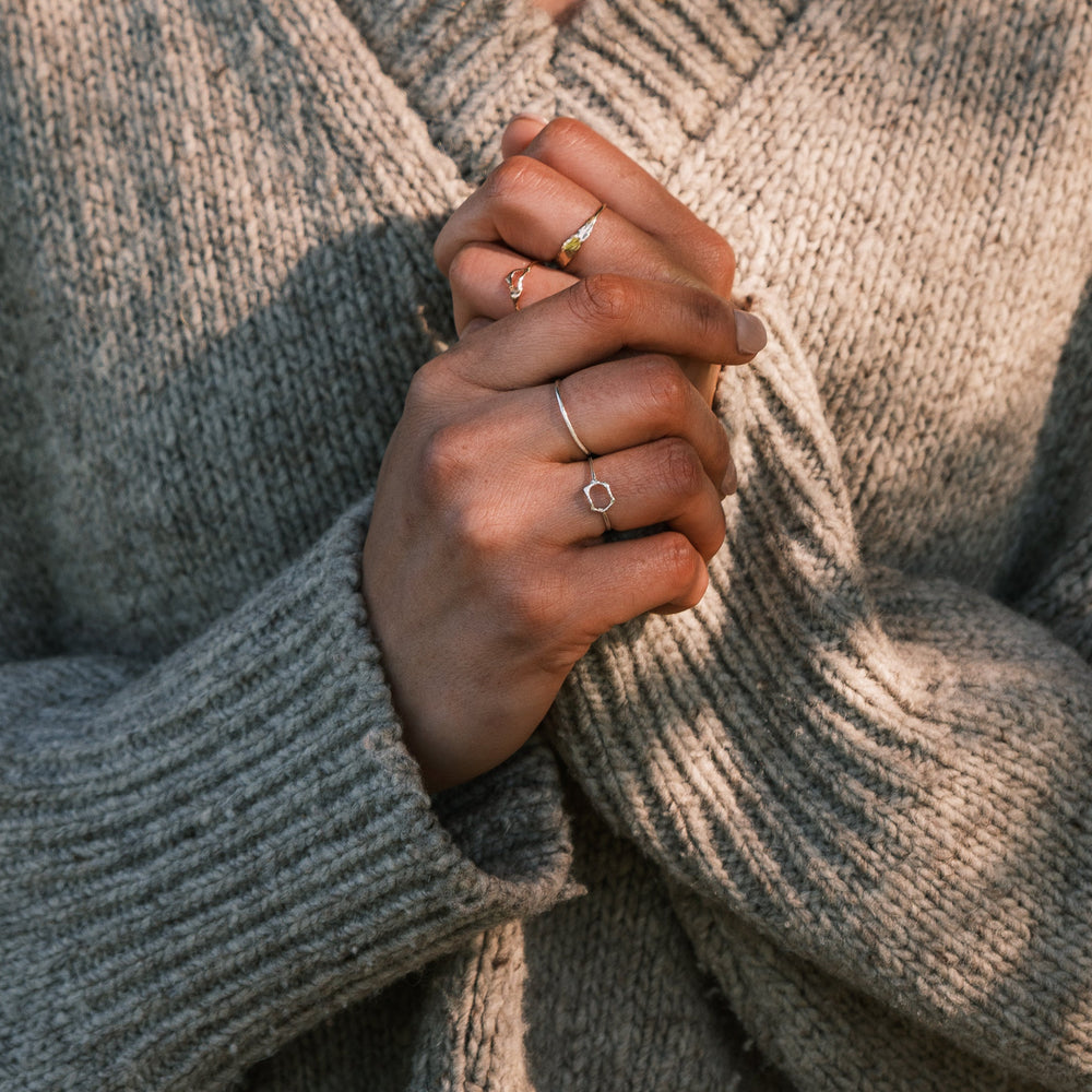 close up of model wearing thicket rings including honeycomb ring