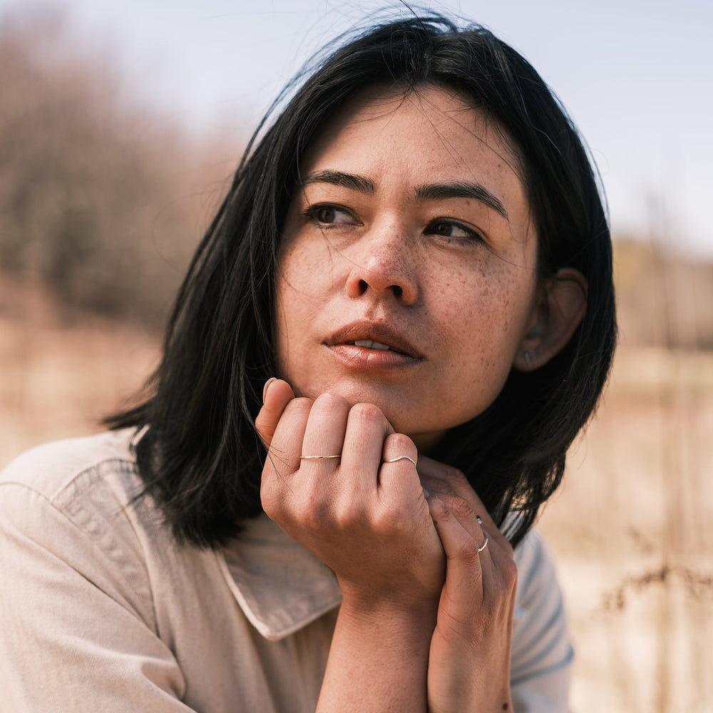 model wearing custom silver river ring