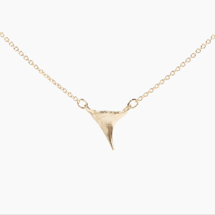 Thicket gold rose thorn necklace on a white background