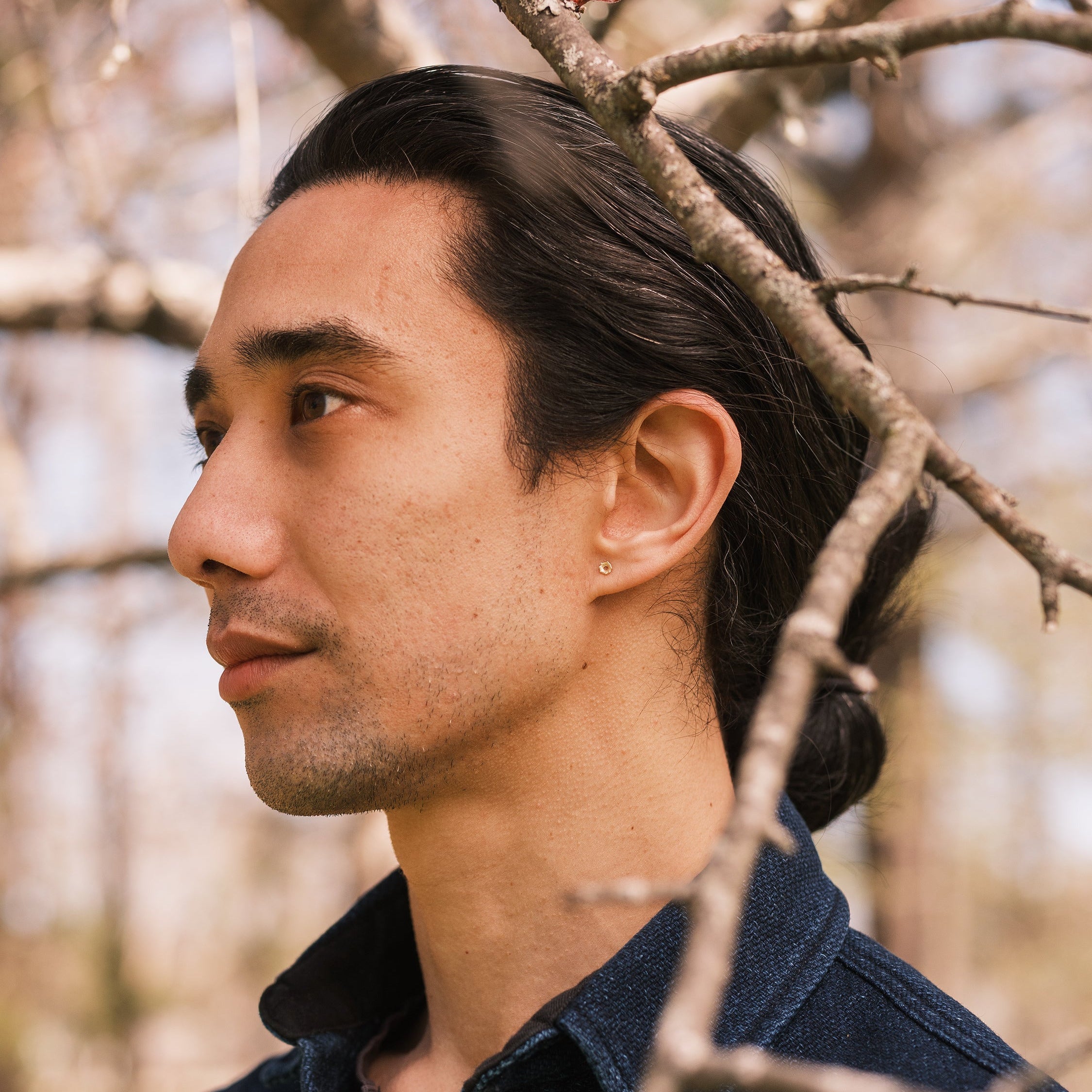 model wearing Thicket's crinoid fossil studs